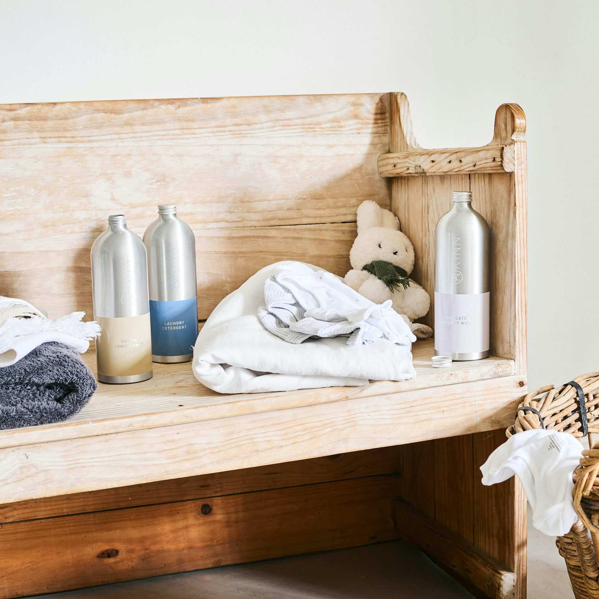 Wooden bench with soft towels and bottles