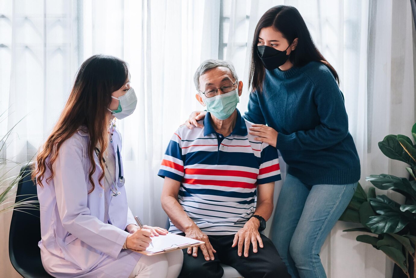 Elderly man supported by family and doctor